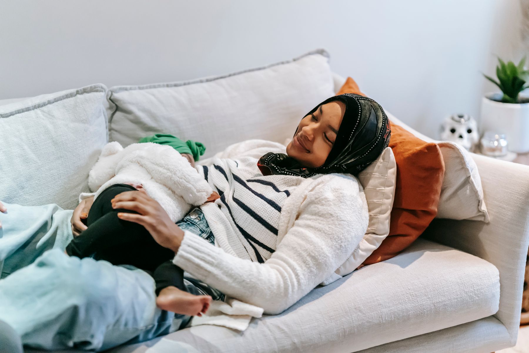 A mother breastfeeding her baby at home