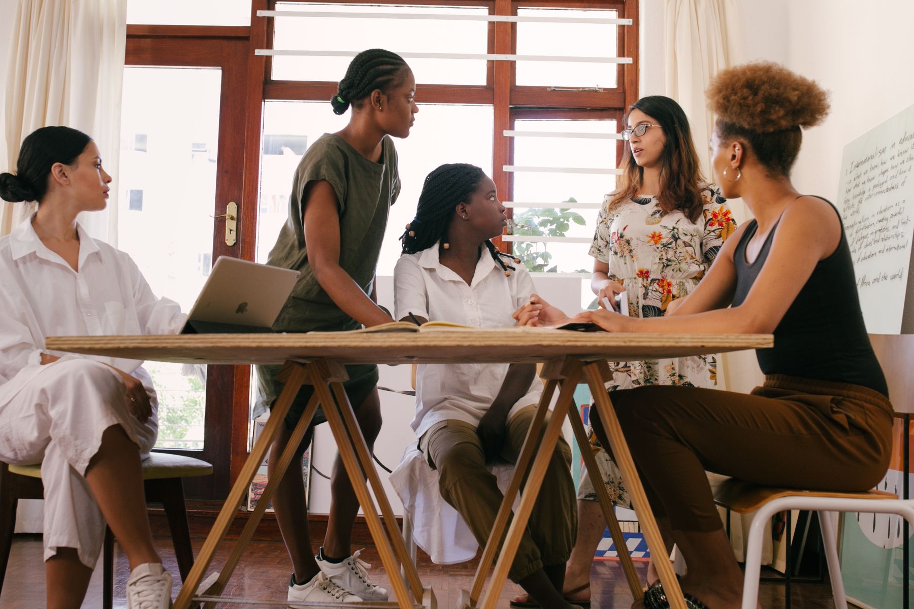 Adult learners sharing notes during a group discussion